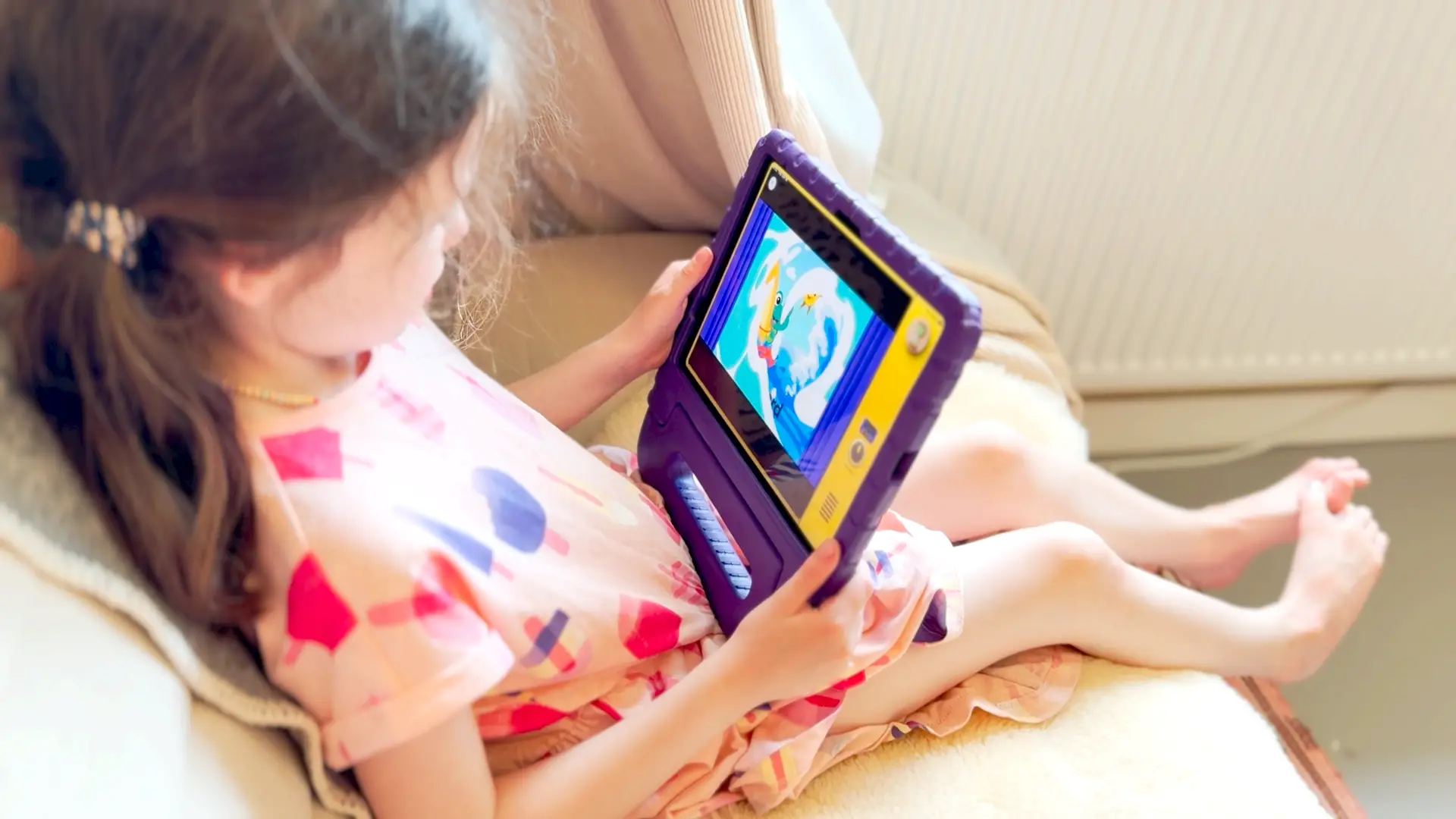 A child watching a claymation Meevee story on a tablet